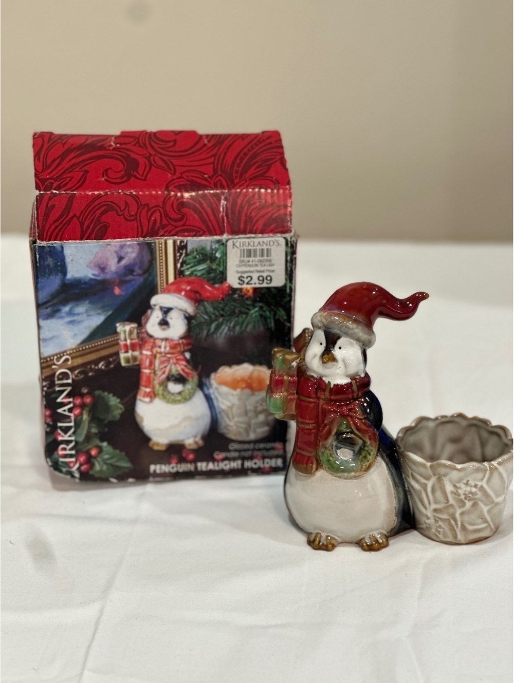 Kirkland's Ceramic Penguin Tealight Holder with Christmas Hat and Wreath